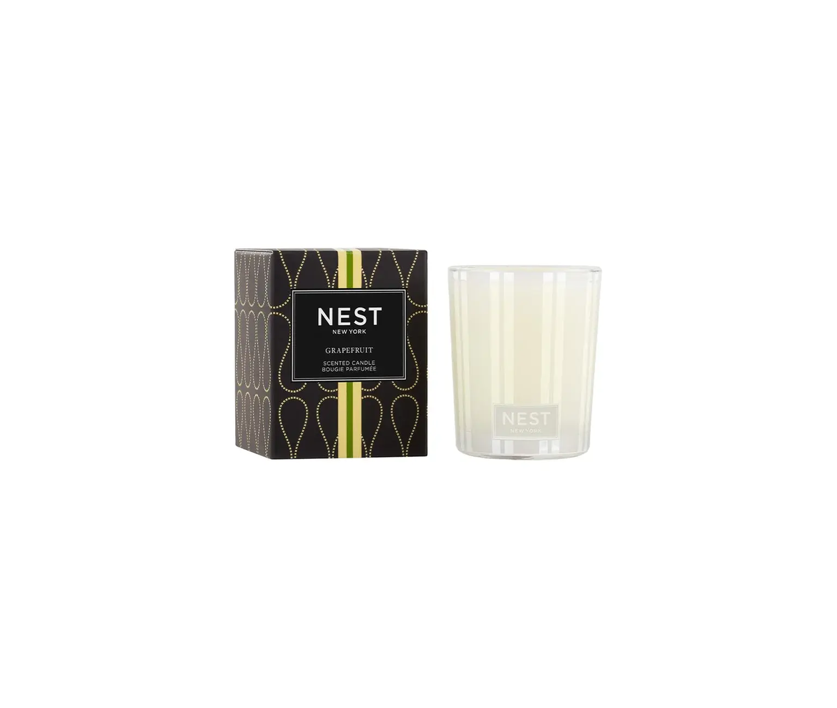 Nest Votive Candle in Gapefruit scent with a smooth white wax silhouette and glass container.