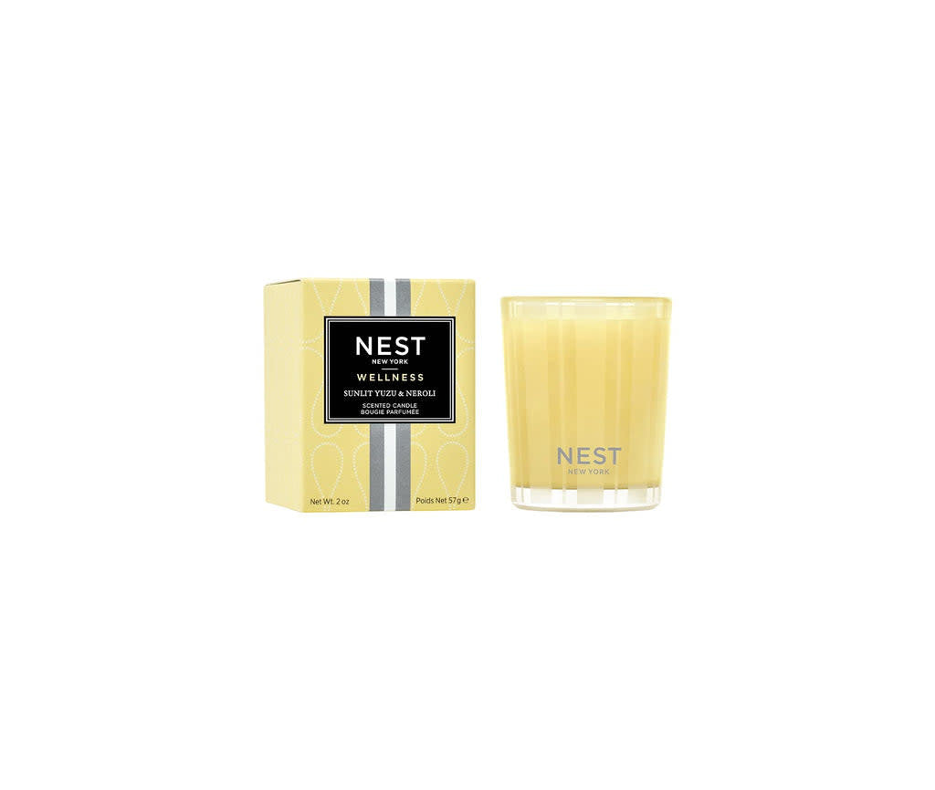 Nest Votive Candle in Sunlit Yuzu Neroli scent with a creamy white wax and glass container.