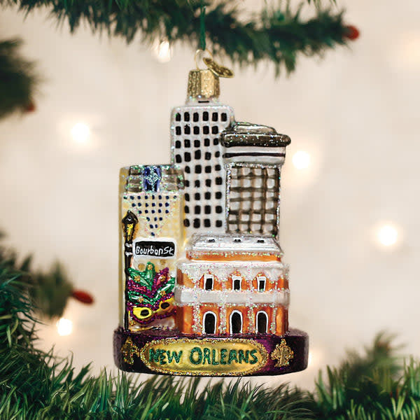 Mouth-blown glass New Orleans ornament with hand-painted silver accents and glitter finish.