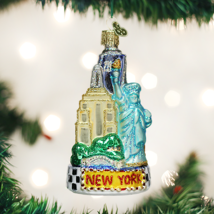Glass New York City ornament with silver finish featuring Statue of Liberty, Empire State Building, and Central Park silhouettes.