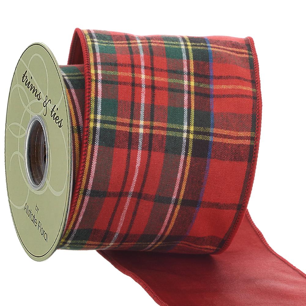 4 inch wide red and green plaid ribbon on a spool with a solid red underside.