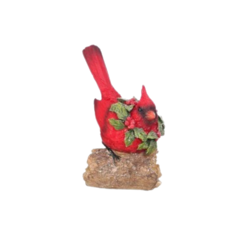 Resin red cardinal figurine with a holly wreath perched on a rustic log.