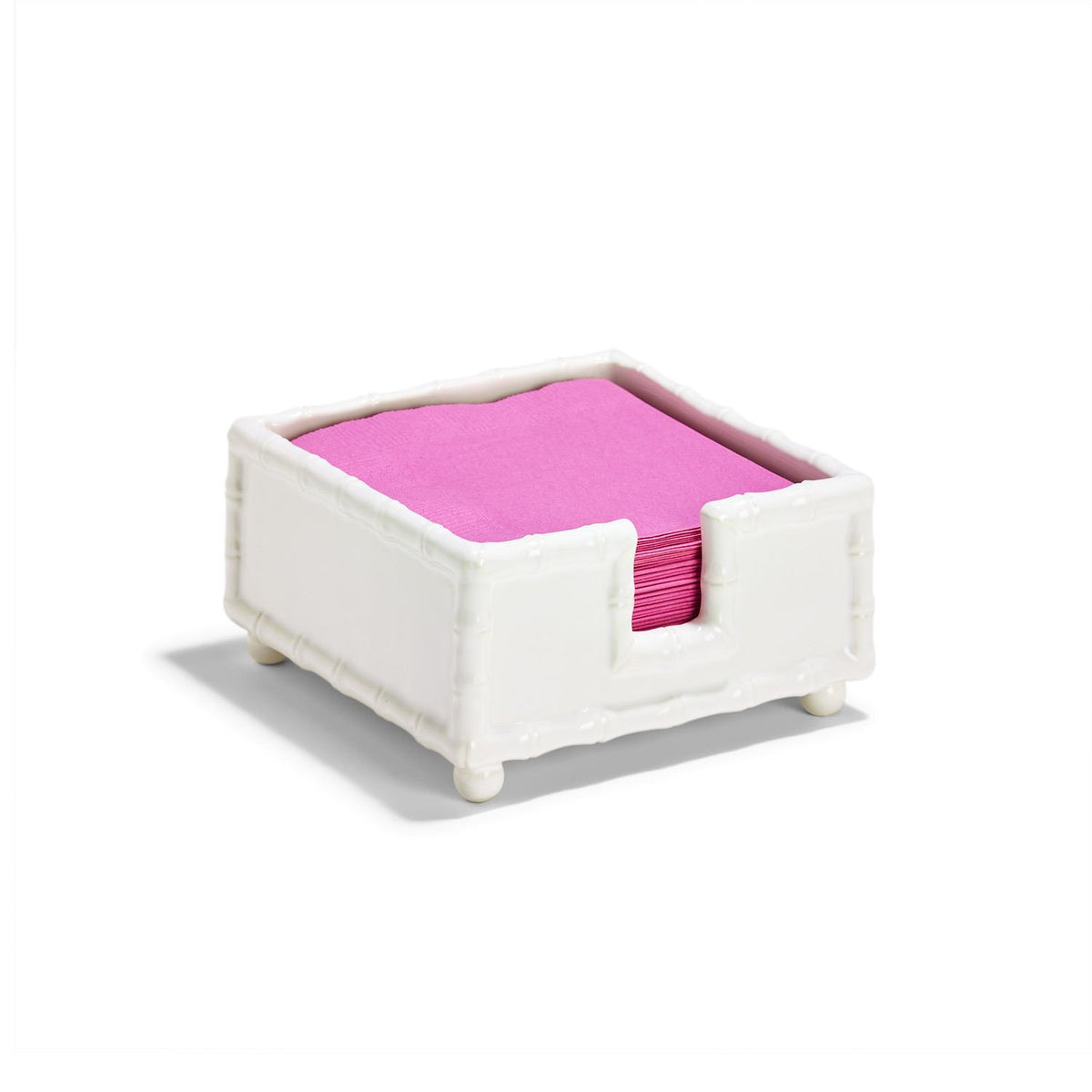 White glazed ceramic Hampton Faux Bamboo Napkin Holder with pink cocktail napkins.