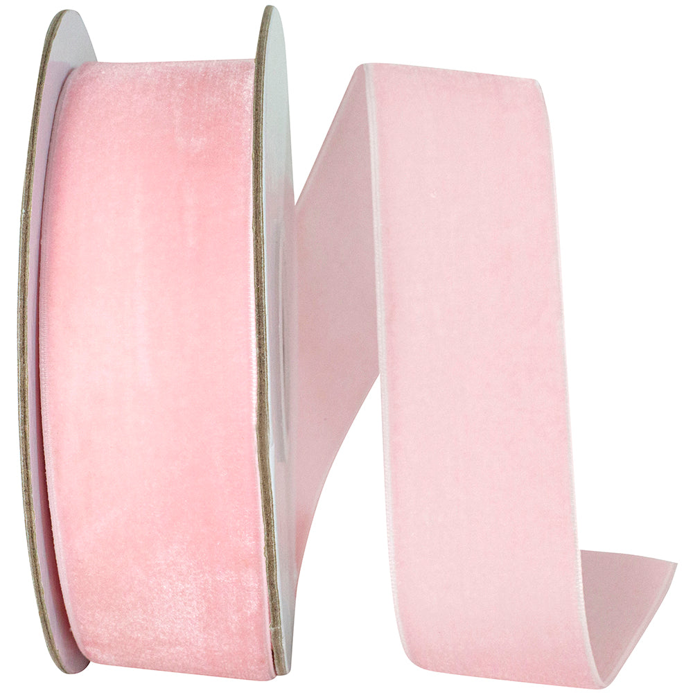 1.5 inch light pink woven edge velvet ribbon on a spool.