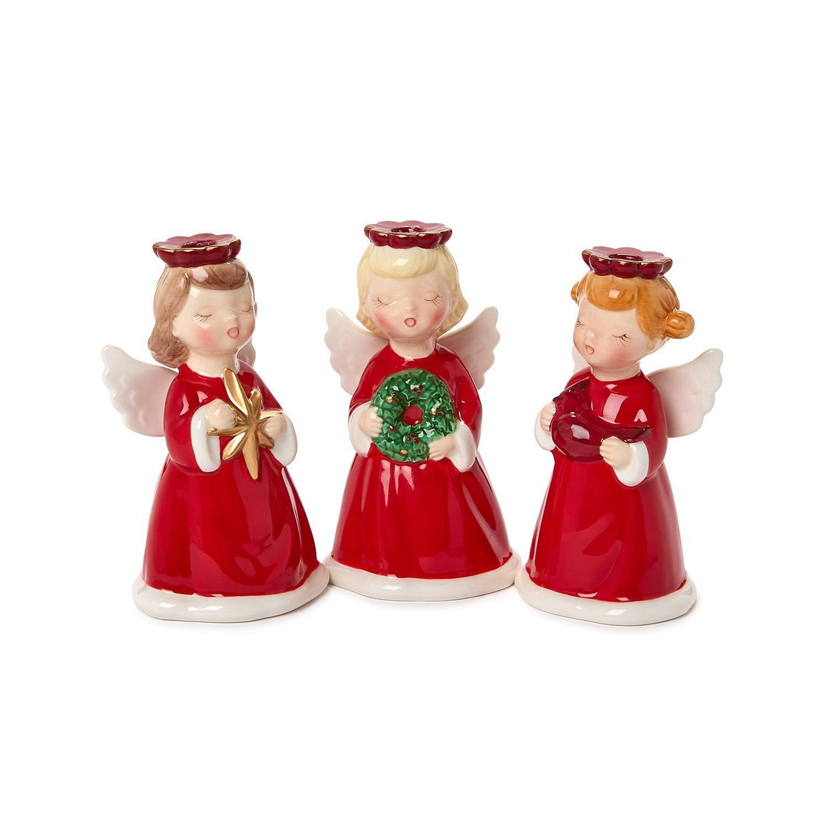 Three hand-painted ceramic Christmas angel candleholders in red dresses holding holiday symbols.