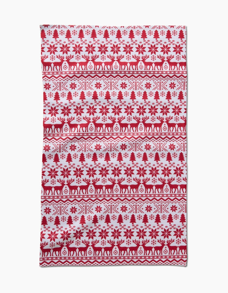 Holiday tea towel with waffle weave construction in red featuring a festive snowflake pattern and hanging loop.