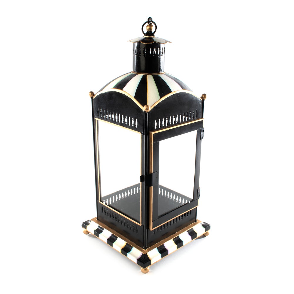 Large iron pagoda candle lantern with hand-painted stripes on glass panels.