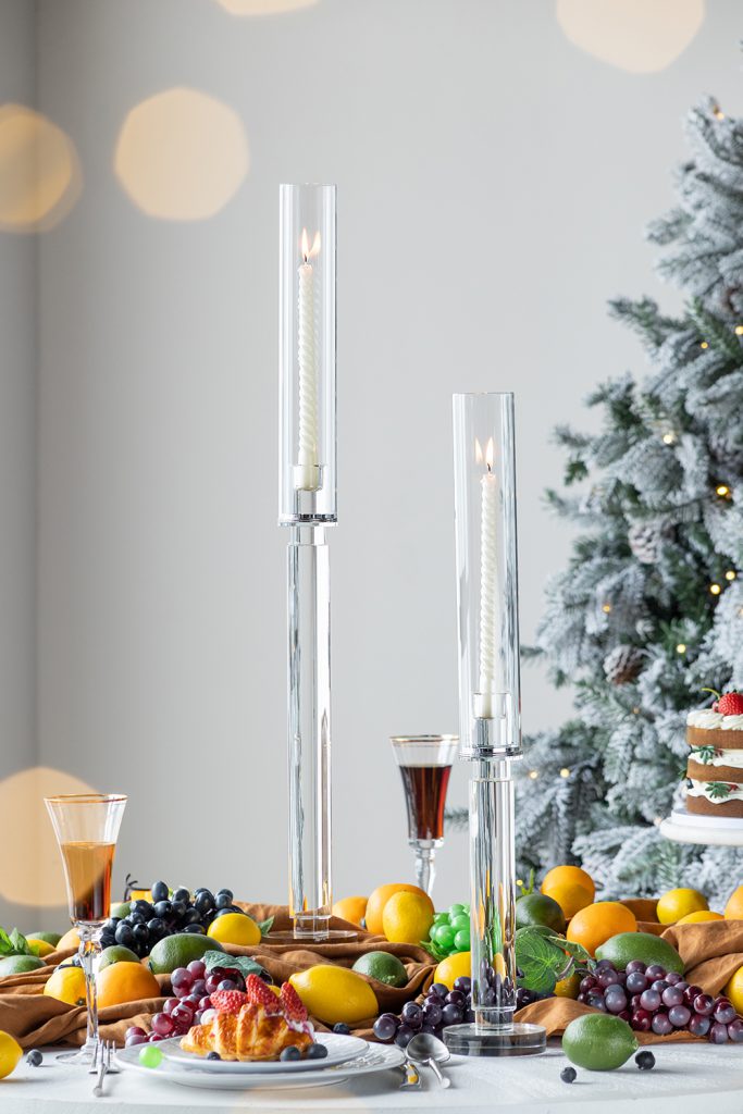 Tall clear glass candle holder with a contemporary cylindrical shape.
