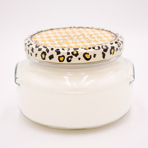 A white ceramic jar containing a Tyler Candle with visible wicks inside.