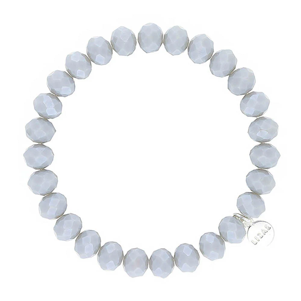 Lizas Quadro Big crystal stretch bracelet with faceted light grey beads and a silver logo charm.