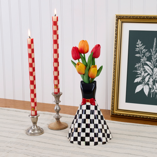 Mon Cheri Short Dress Vase with a black bodice, red bow, and checkered skirt holding tulips.