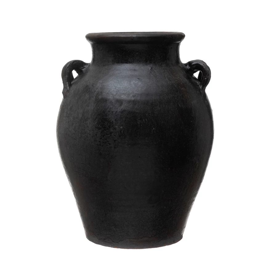 Black found decorative clay jar with two small handles and a weathered finish.