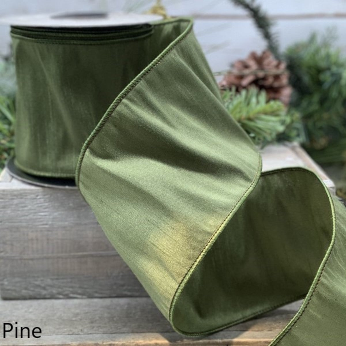 4 inch wide Pine green Georgette Dupion ribbon with wired edges on a spool.