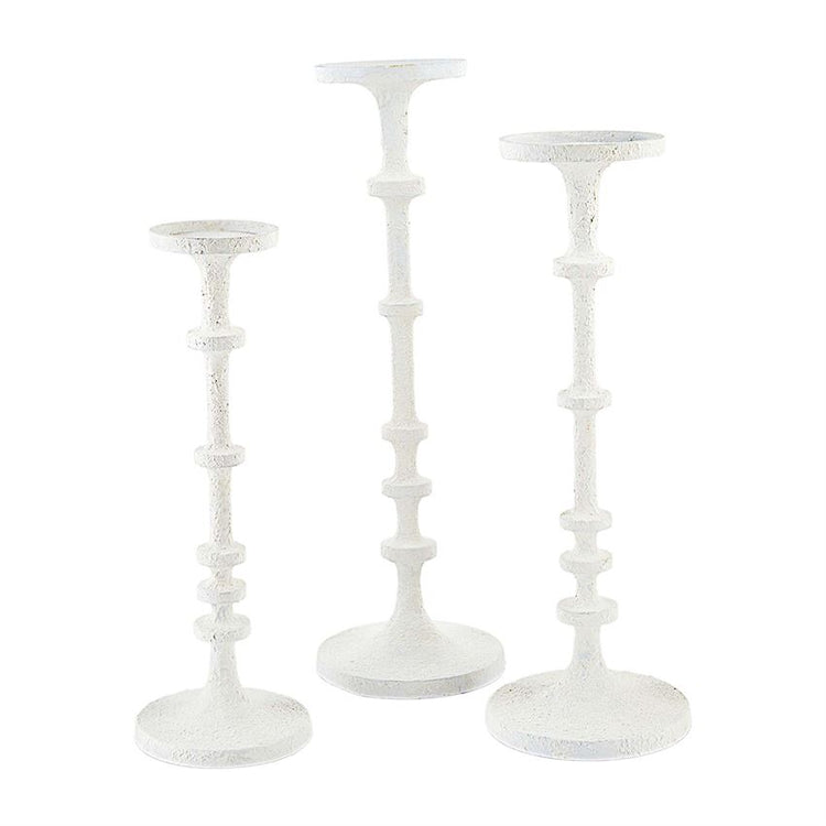 White metal candlesticks with a sleek cylindrical silhouette