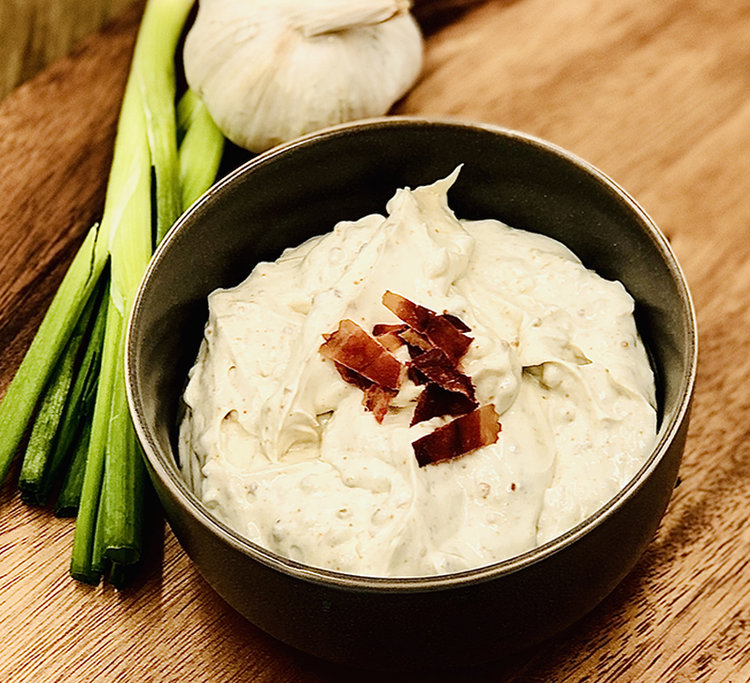 Bag of Cheddar Bacon Dip Mix with visible seasoning specks
