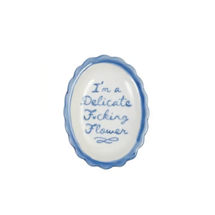 Oval scalloped stoneware dish with blue script reading "I'm a Delicate F*cking Flower".