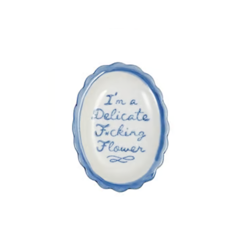 Oval scalloped stoneware dish with blue script reading "I'm a Delicate F*cking Flower".