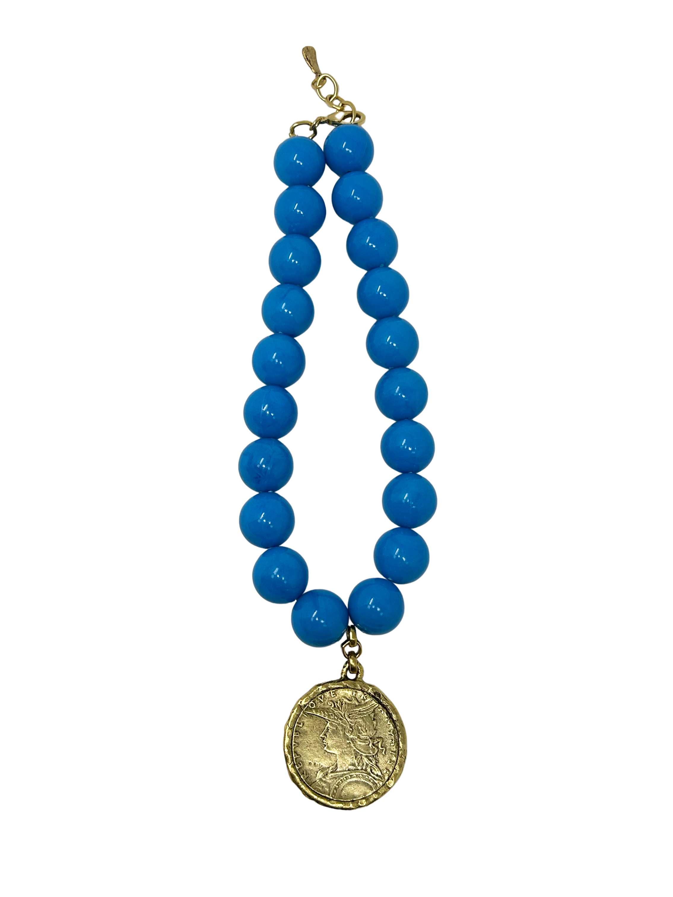 Vintage 18-inch necklace featuring large bright blue beads and a gold-tone coin medallion pendant.