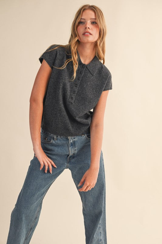 Woman wearing a charcoal grey Jean Cap Sleeve Collared Sweater Vest with blue jeans.