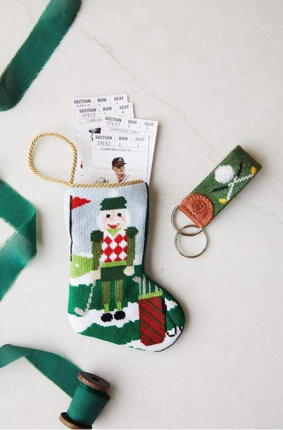 Needlepoint Christmas Birdie Nutcracker stocking with golf theme, tickets, and matching keychain.