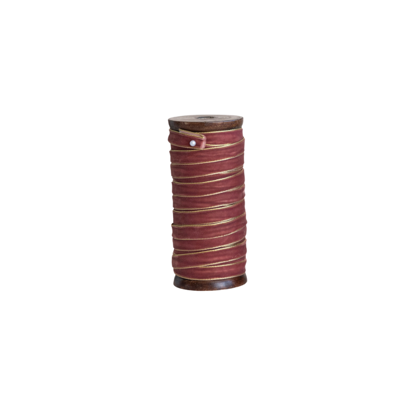 10 yards of burgundy velvet ribbon with metallic gold edges wrapped around a vintage wood spool.