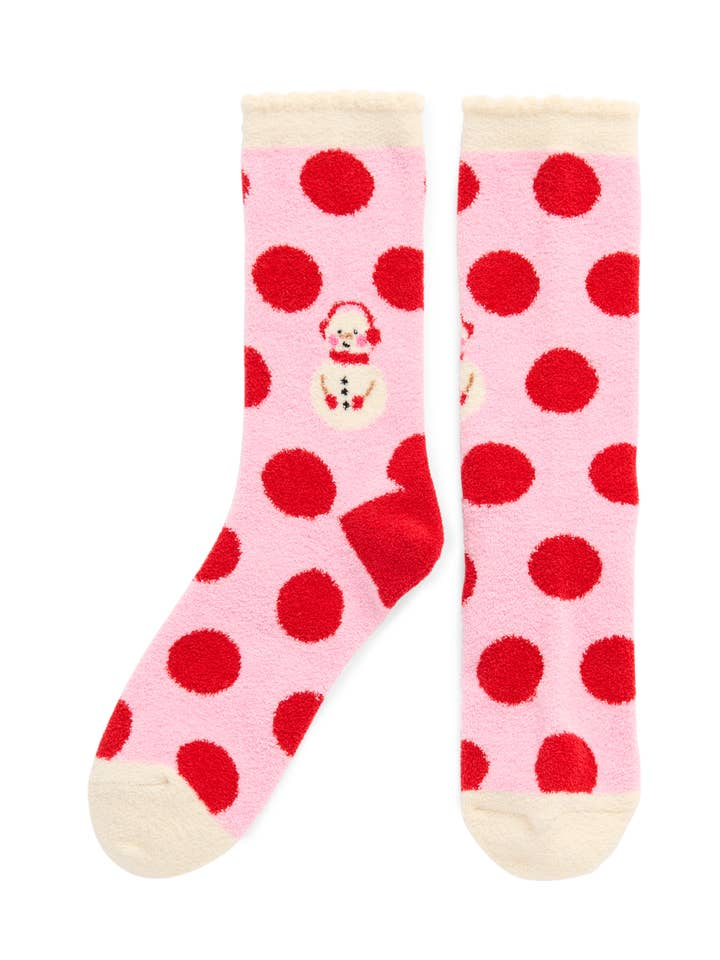 Pink fuzzy crew socks with red polka dots and a small snowman graphic.