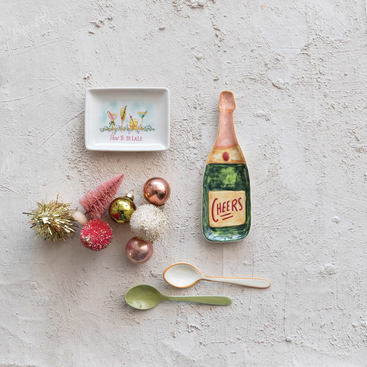 Multi-color stoneware dish shaped like a champagne bottle with 'Cheers' text.
