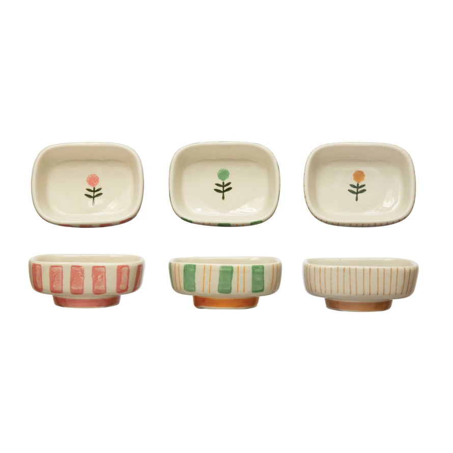 Hand-painted stoneware dish featuring blue stripes and a floral pattern with an oval silhouette.