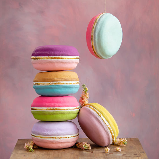 Hand-painted gold leafed half-moon macaroon on a black background