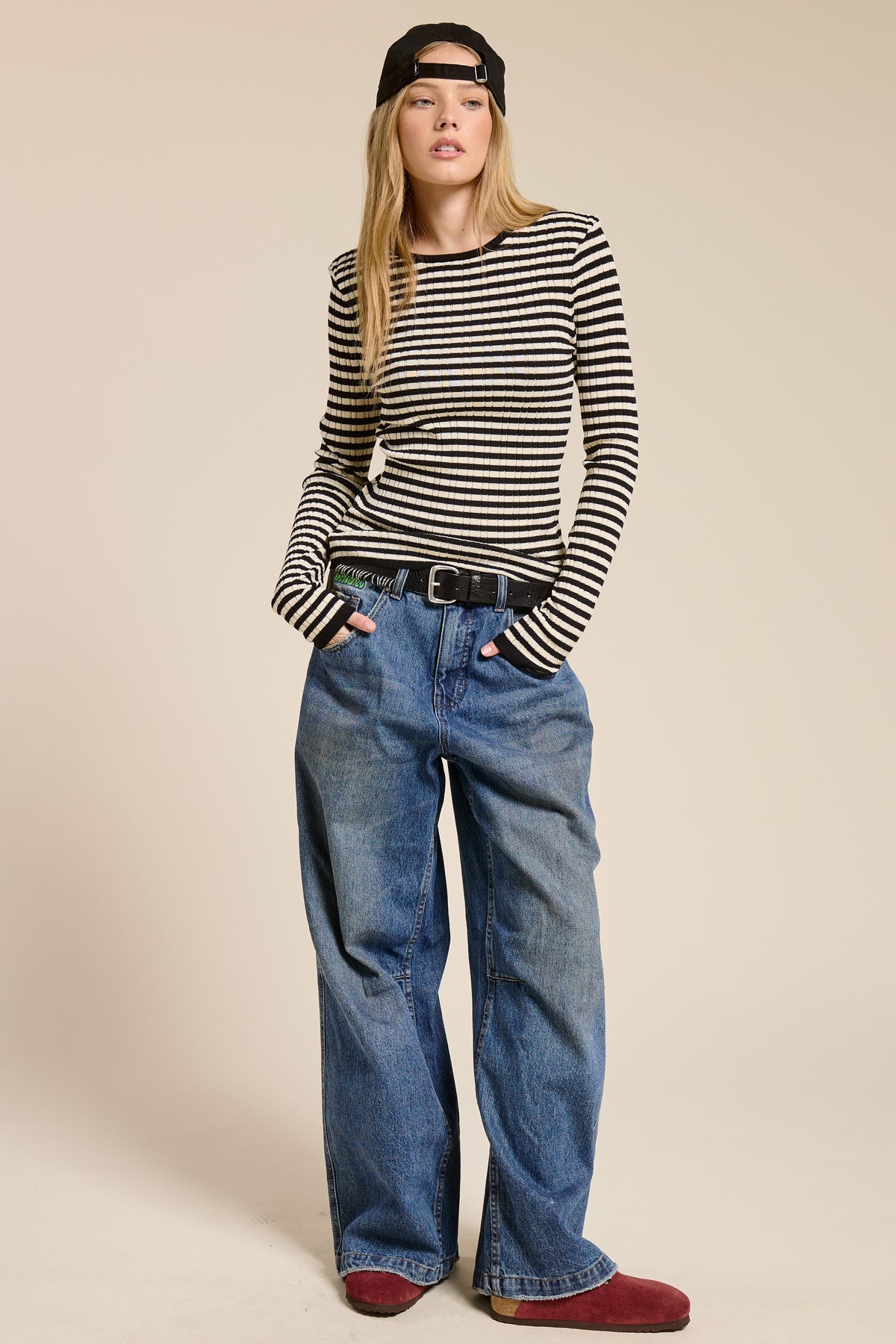 Women's long-sleeve ribbed knit top with horizontal warm neutral stripes, crew neckline, and snug silhouette.