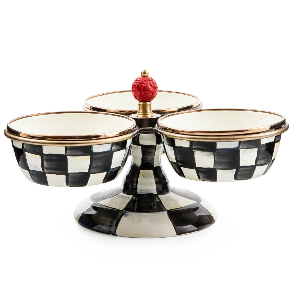 Courtly Check Triplicity serving stand with three black and white checkered bowls and a red finial.