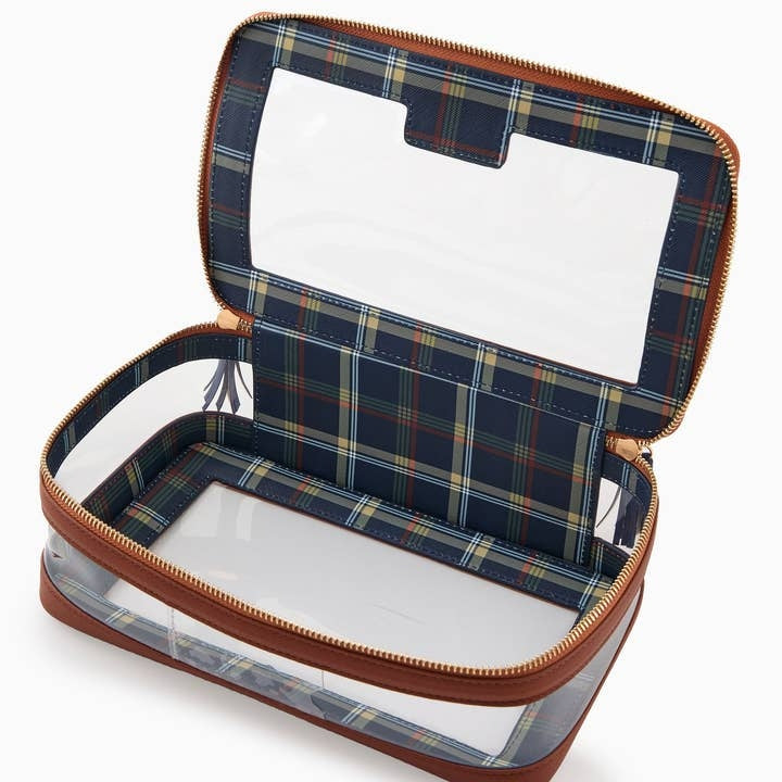 Open cognac-trimmed clear storage bag with a navy and red plaid interior and zippered closure.