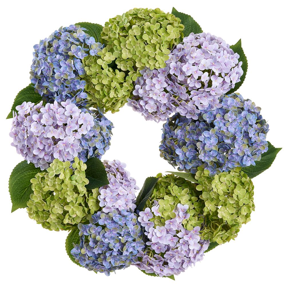 Round artificial hydrangea wreath with mixed green plastic leaves on a rattan base.