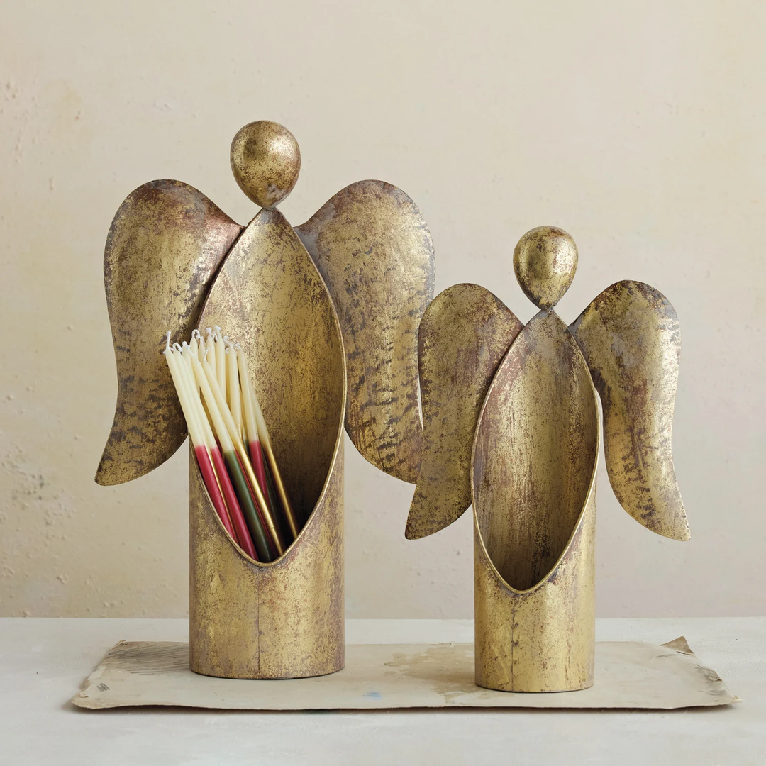 Two antique gold finish metal angel containers in different sizes, one holding thin taper candles.