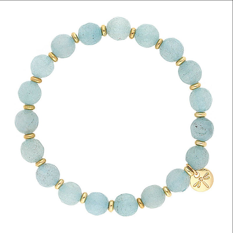 Lizas Beaumont Natural Bracelet with light blue stone beads and gold-toned spacers and charm.