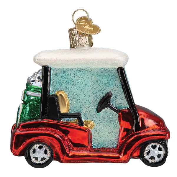 Red glass golf cart Christmas ornament with a white roof, green golf bag, and gold heart charm.