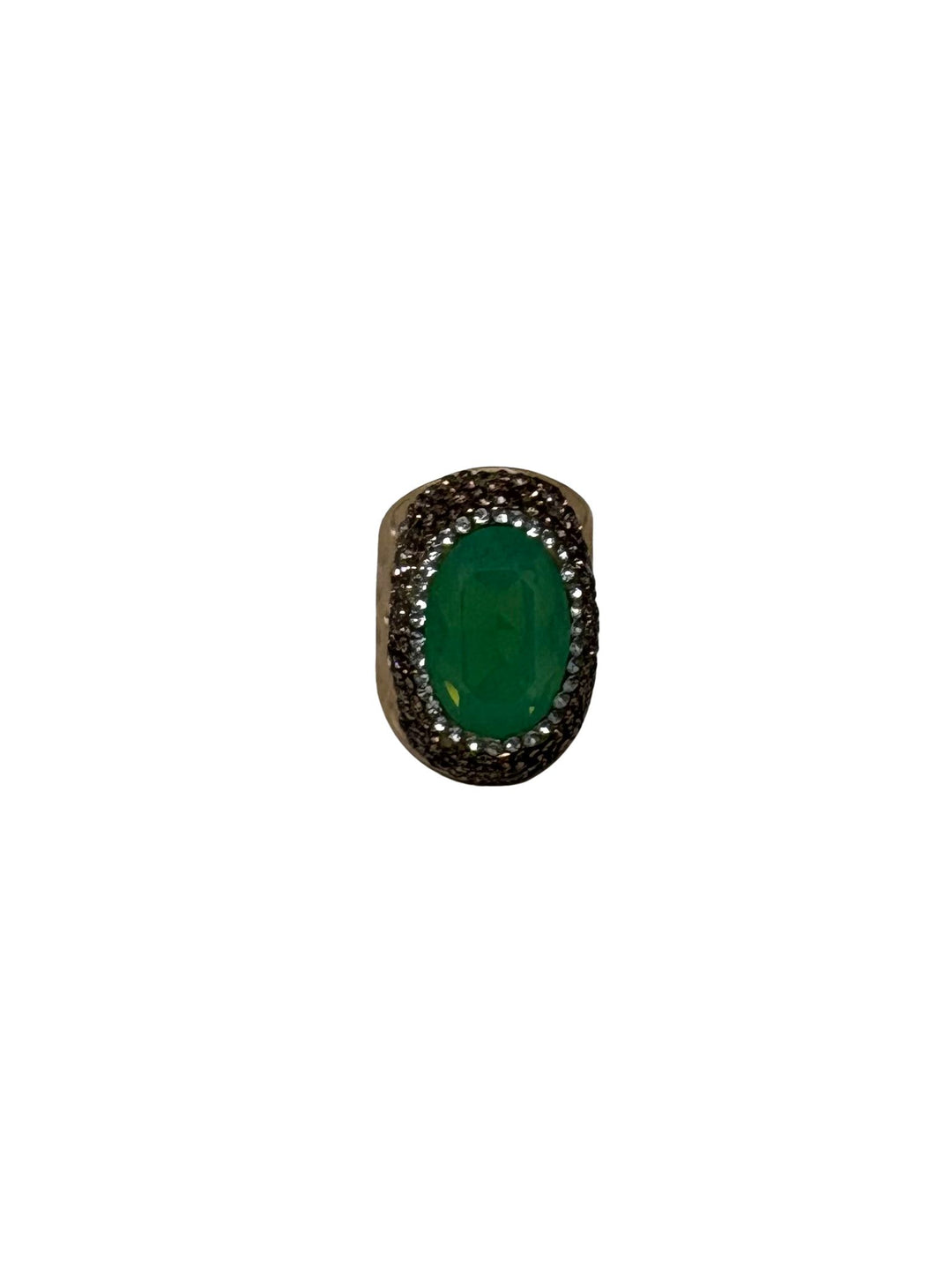 Fashion gemstone ring featuring a large oval green emerald center stone with a textured halo.