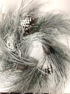 Artificial snowy mixed pinecones in a natural brown color with white flocking.