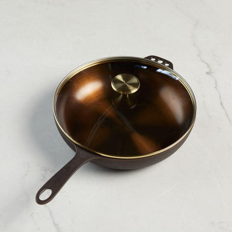 No. 11 deep cast iron skillet with satin-smooth interior, glass lid, and stainless steel knob.