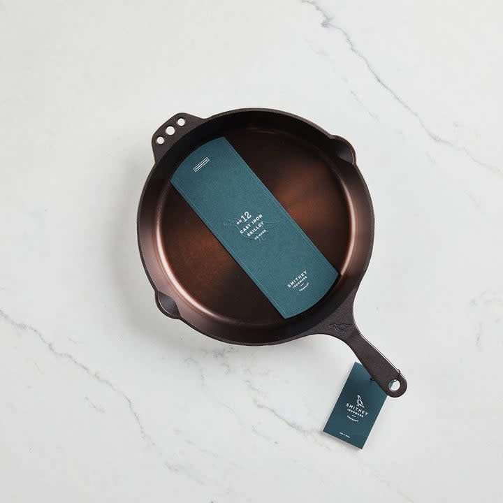 No. 12 cast iron skillet with polished interior finish, ergonomic handle, and pour spouts.