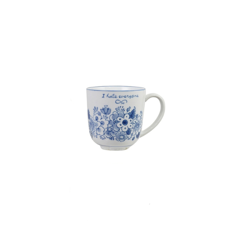 Blue and white stoneware mug with floral designs and the text "I hate everyone".