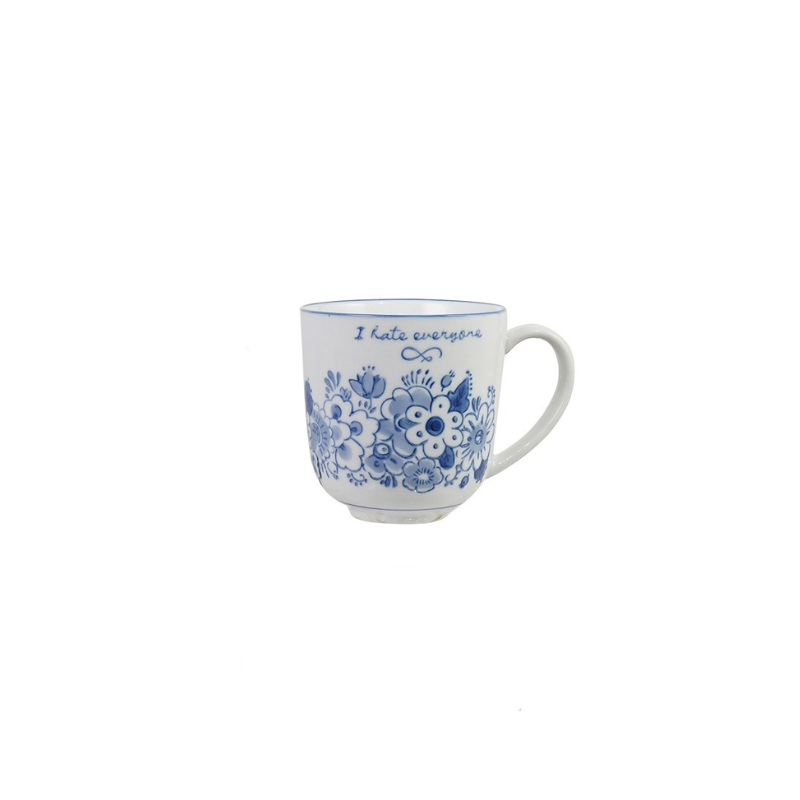 Blue and white stoneware mug with floral designs and the text "I hate everyone".