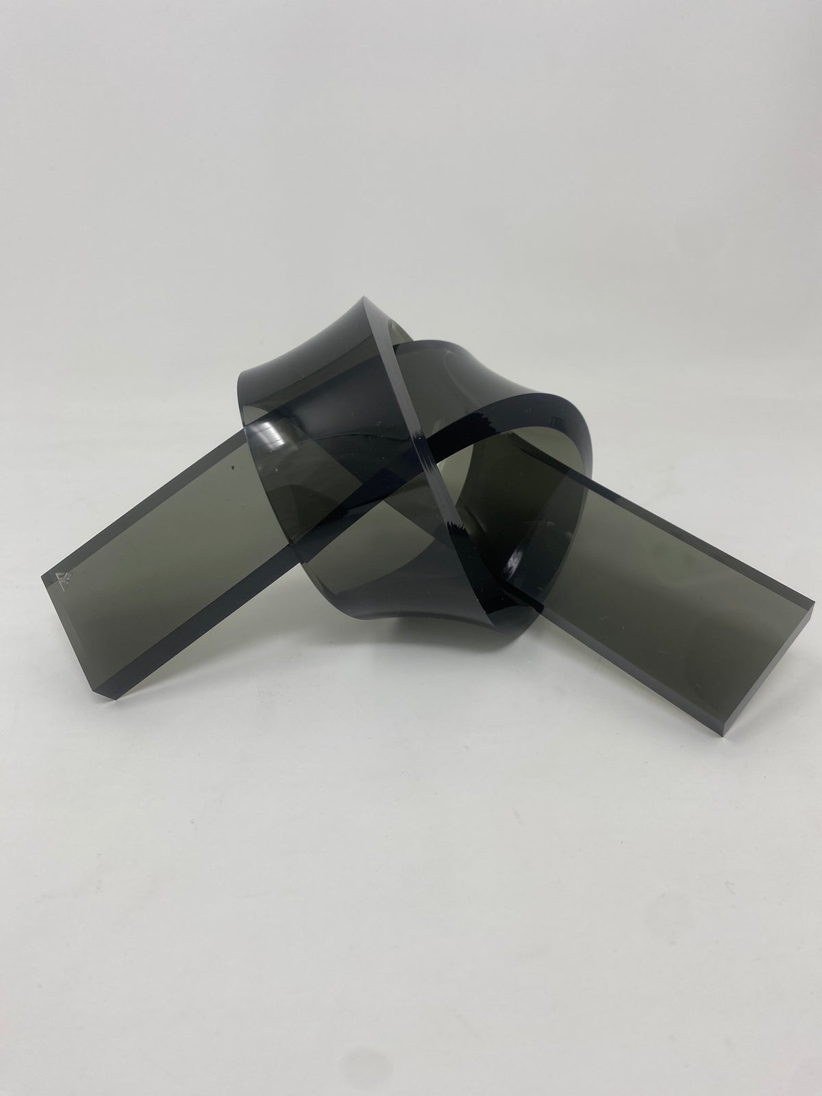 Acrylic knot pendant in clear acrylic with a black cord chain.