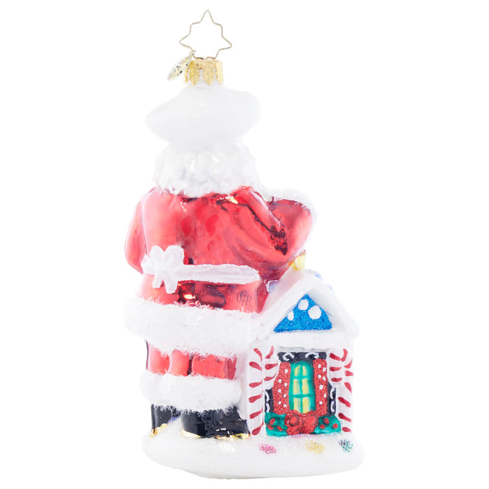 North Pole Bake Off ceramic mug featuring Santa Claus in a chef's hat baking cookies on the back.