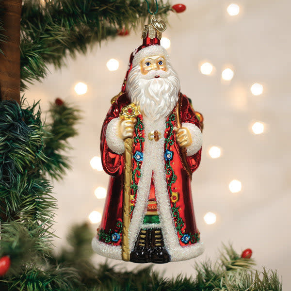 Norwegian Santa ornament featuring a red suit with white trim, black boots, and a green hat against a gold background.