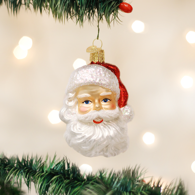Mid-century style ornament shaped like Santa's head in red with white beard.