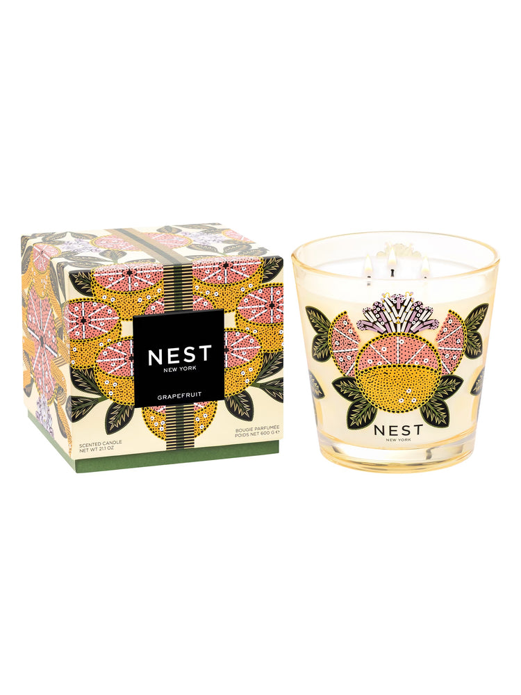 Nest Grapefruit 3-wick candle in a decorative glass jar next to its matching patterned box.
