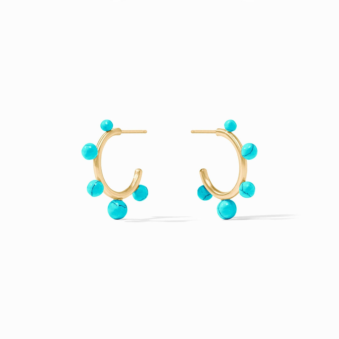 Slender golden hoop earrings studded with varying sizes of gumdrop-like gemstones.