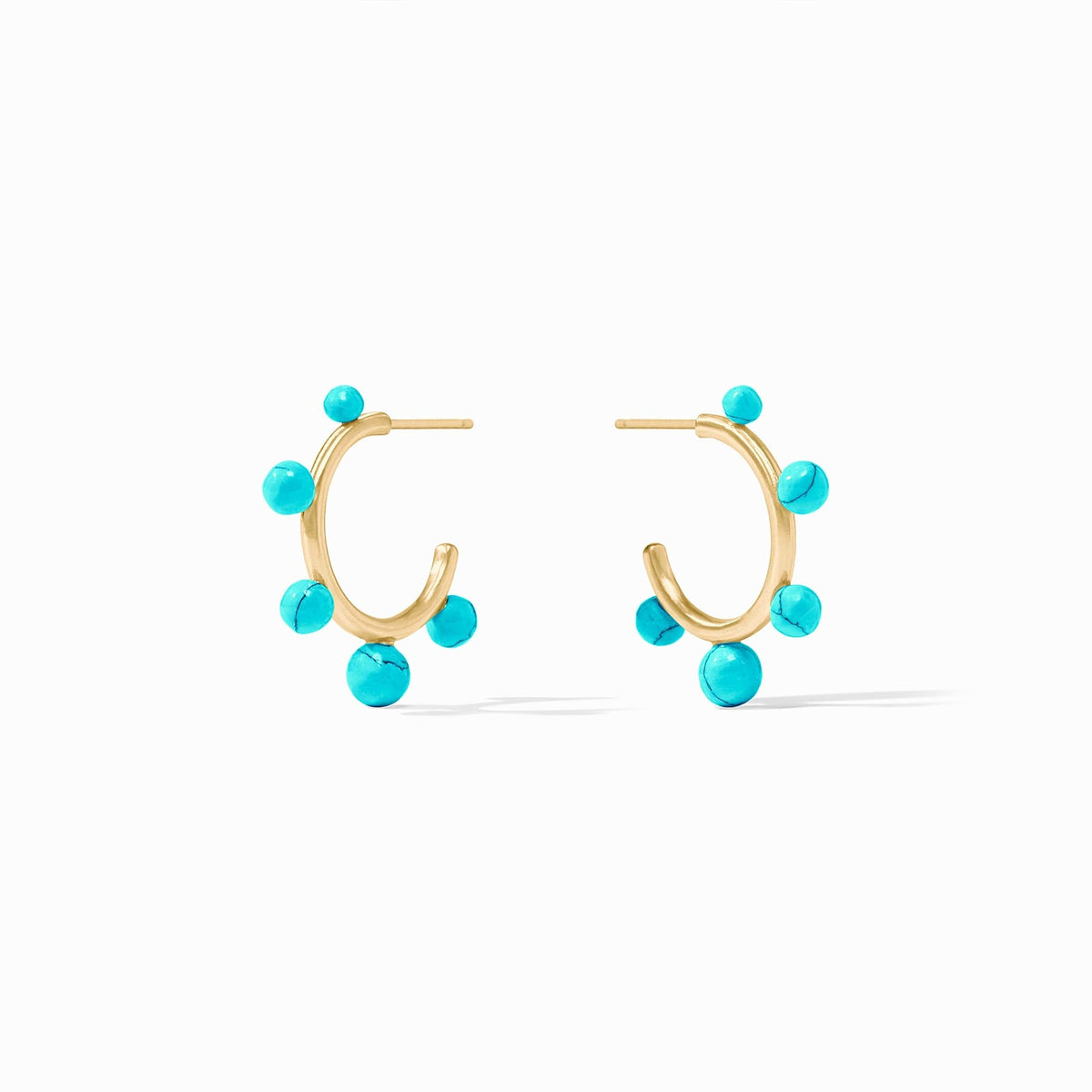 Slender golden hoop earrings studded with varying sizes of gumdrop-like gemstones.