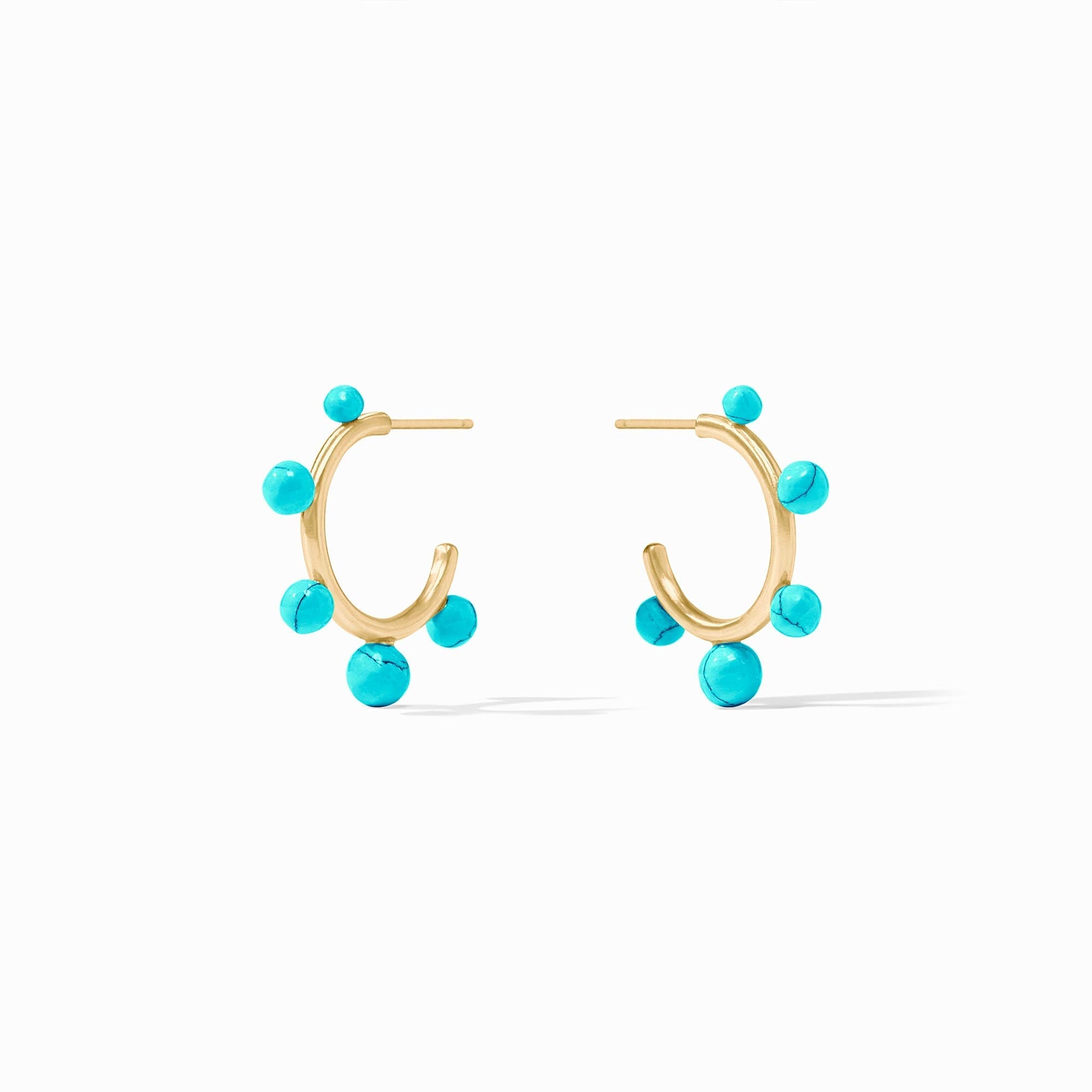 Slender golden hoop earrings studded with varying sizes of gumdrop-like gemstones.